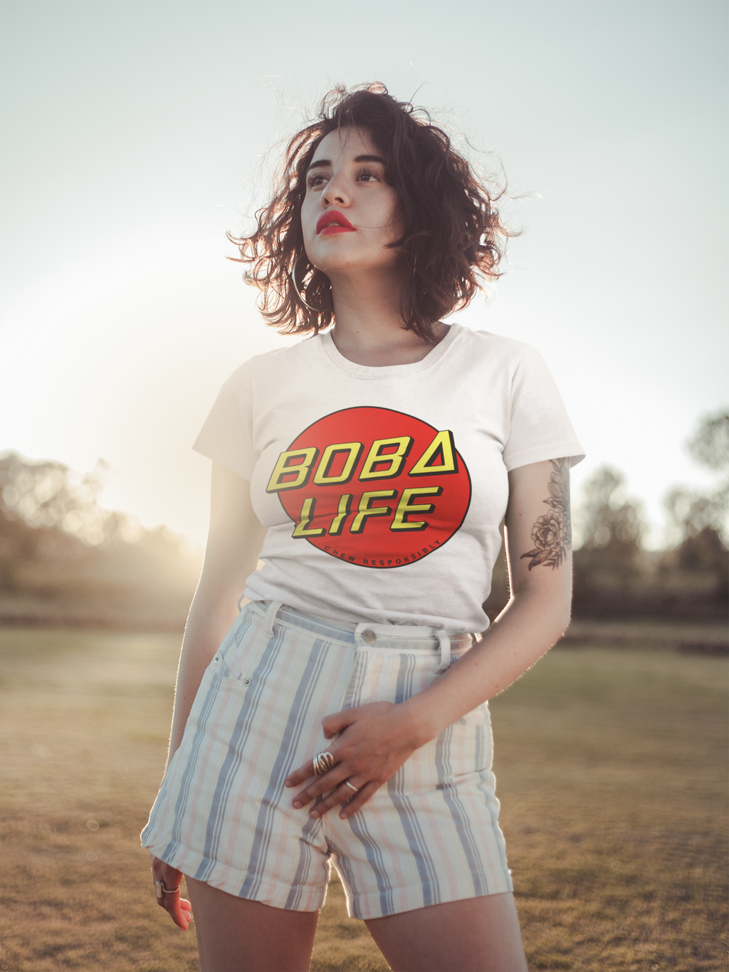 Woman wearing a Boba Life T-Shirt against the sunset 