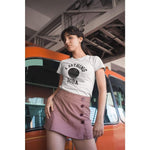 A woman wearing a Bathing Boba shirt posing against a car