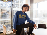 Man wearing a UC Boba Sweater In Front of An Office