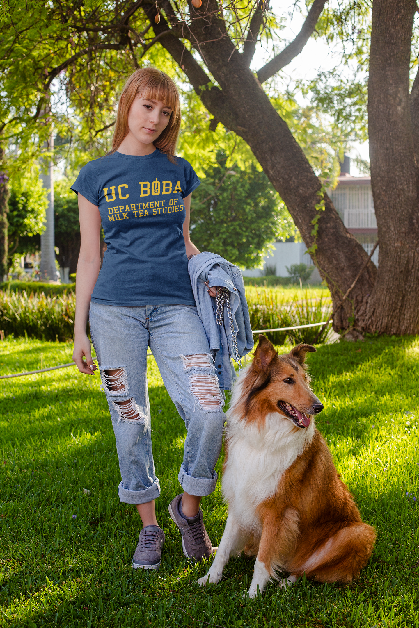 Woman wearing a UC Boba Shirt standing next to a dog