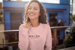 Smiling woman wearing a Boba Bae sweater
