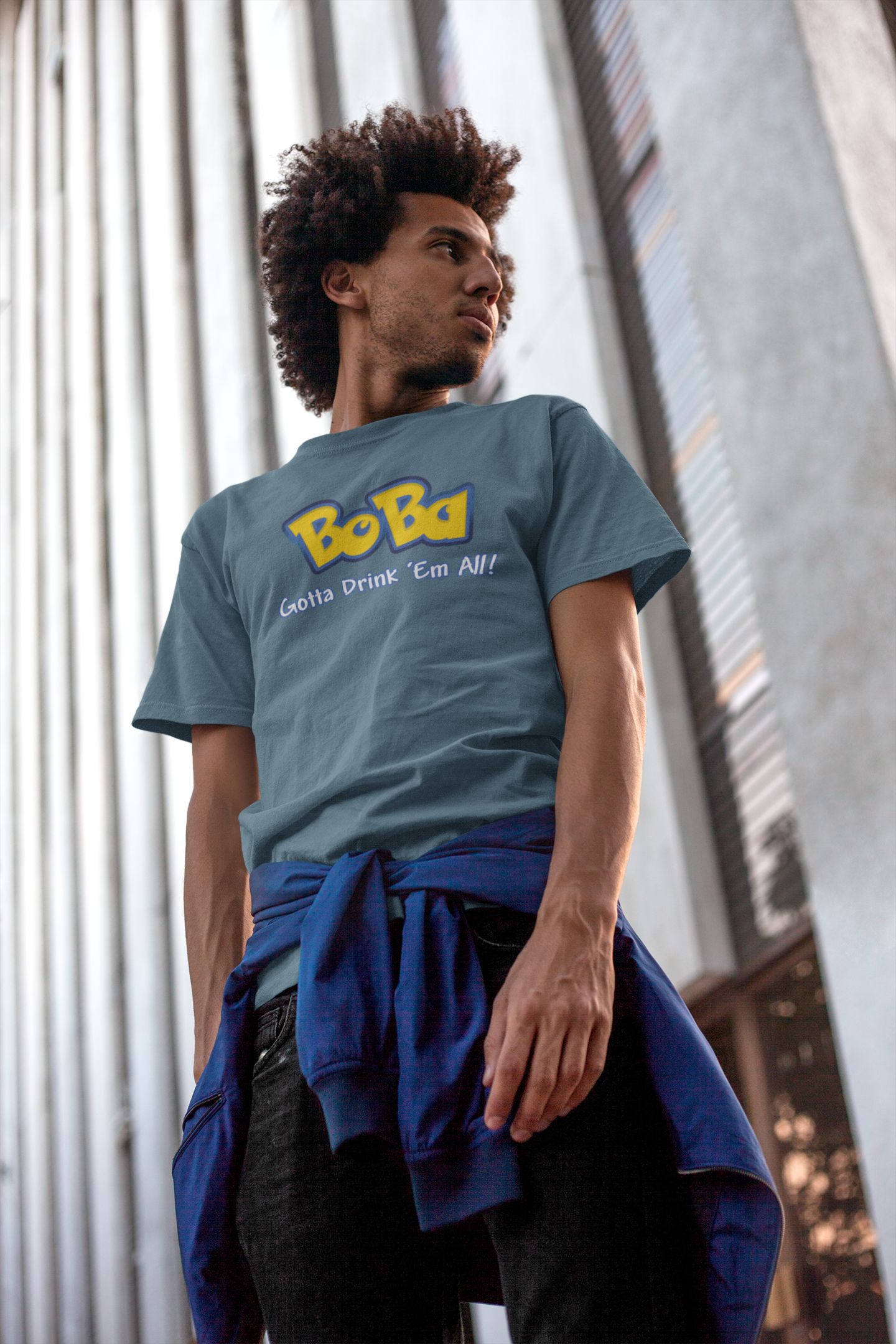 Man wearing a light blue Bobamon shirt leaning against a wall - Pokemon Parody