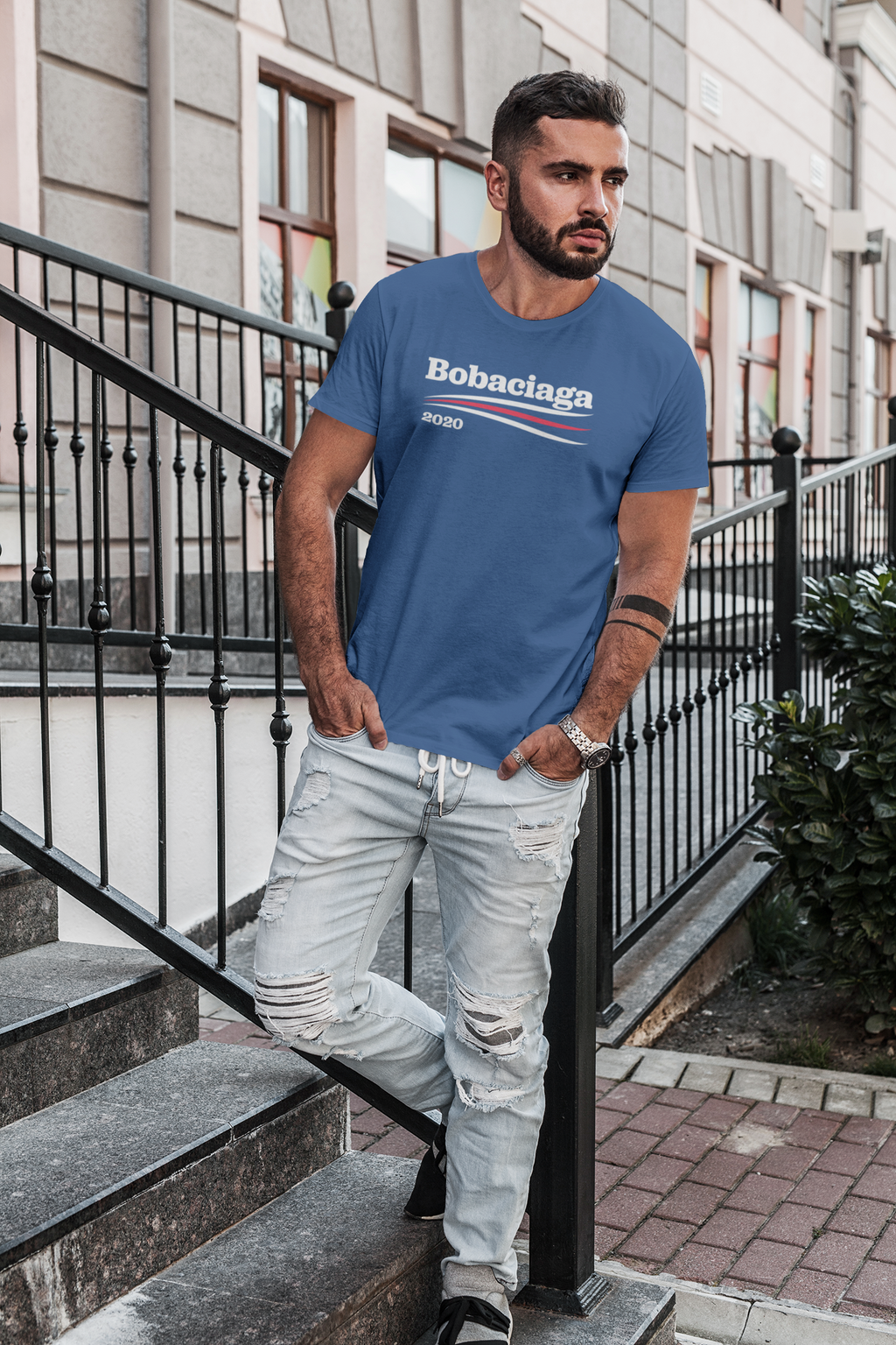Man wearing Bobaciaga 2020 shirt posing against a fence