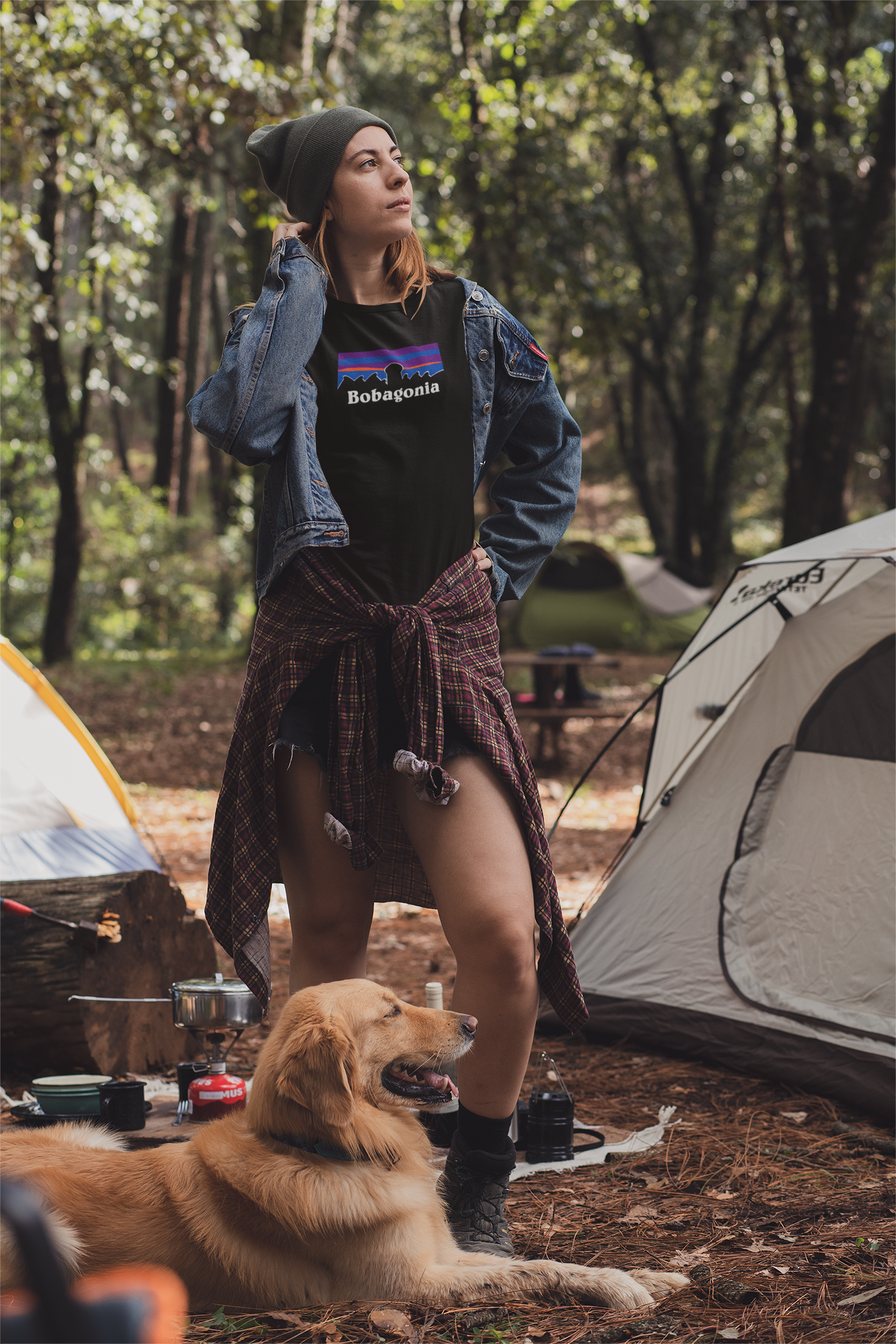 Woman wearing a black Bobagonia shirt with a golden retriever 