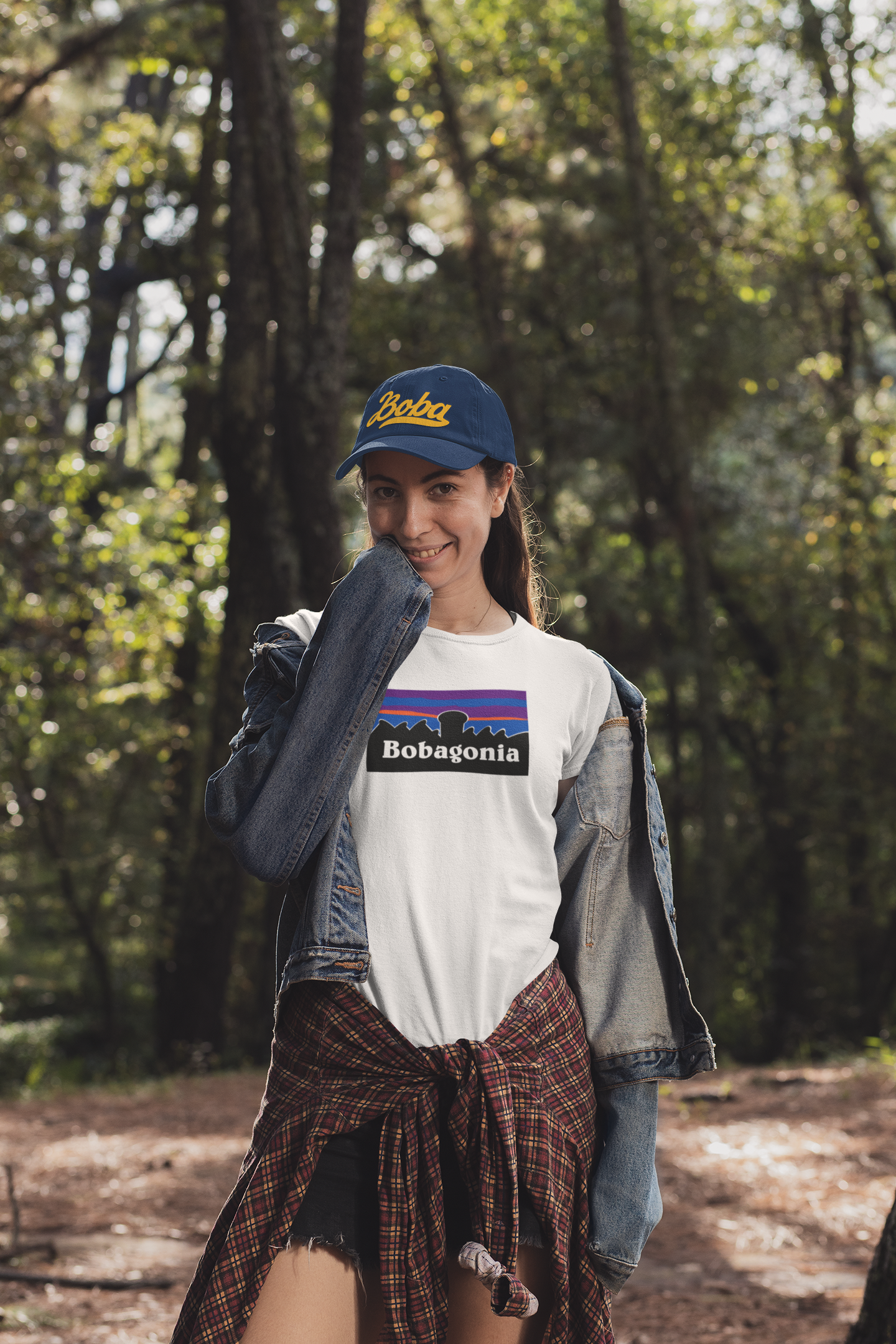 Woman wearing a boba hat in camping gear and a white Bobagonia t-shirt