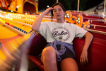 Woman in a carnival seat wearing sponsored by ABG Shirt